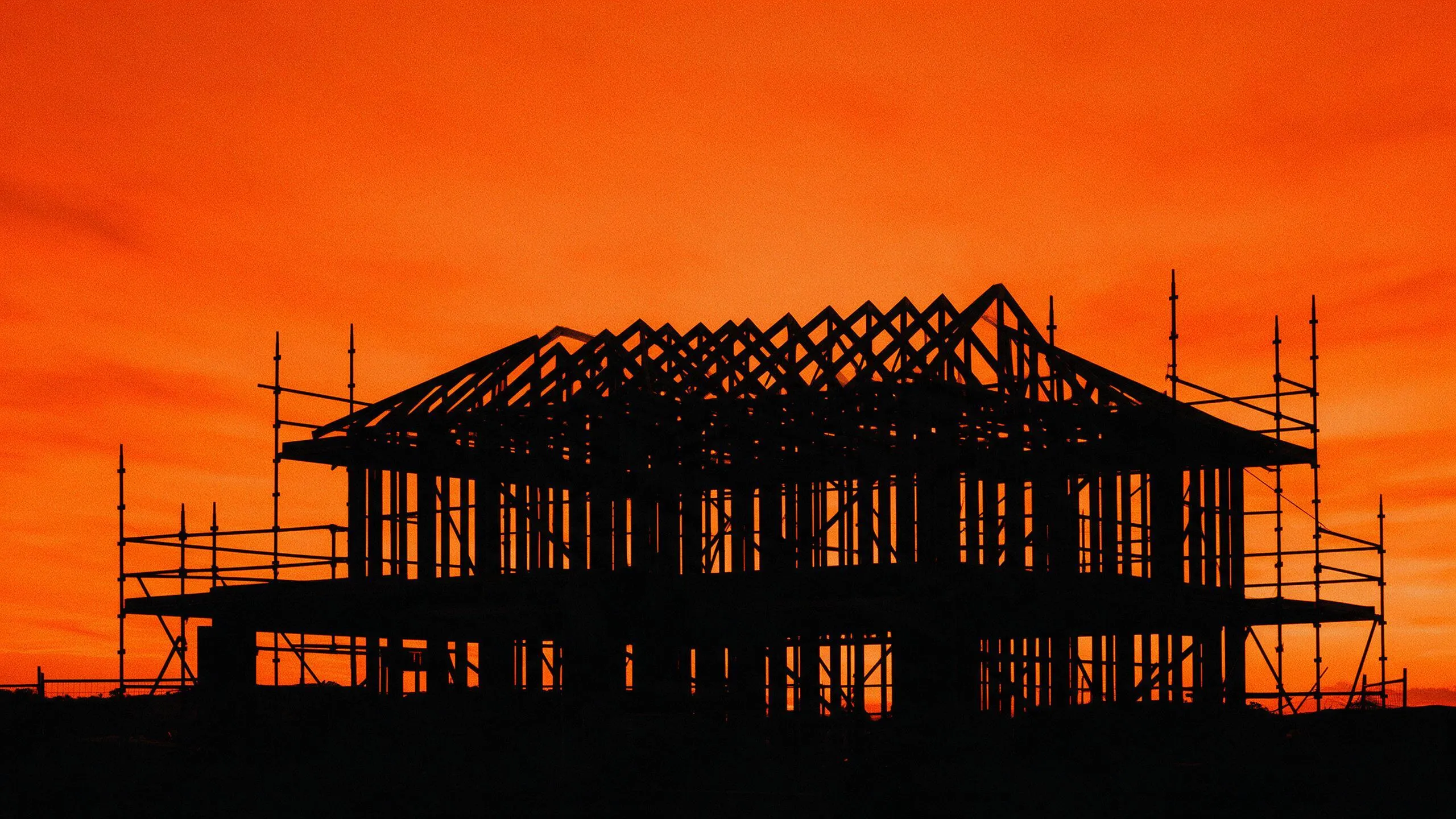 Timber-framed house against an orange sunset